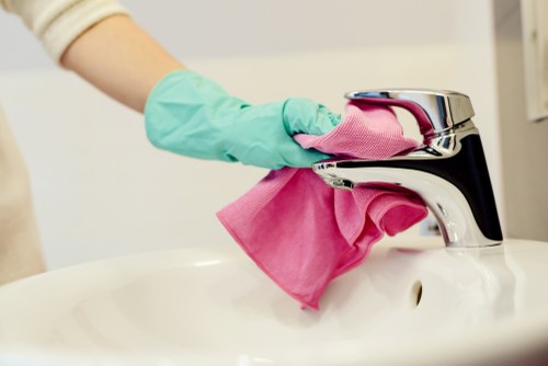 Professional cleaner maintaining an office kitchen in N10