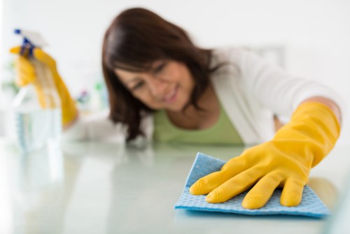 Local technician cleaning a hard floor in a North London flat